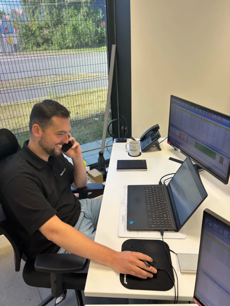 Rapid Energy's new Sales Executive is working at this laptop while on the phone.