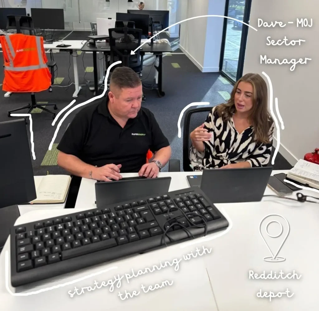 Rapid Energy Business Development Manager Ellie working alongside Dave MOJ Sector Manager at her laptop.