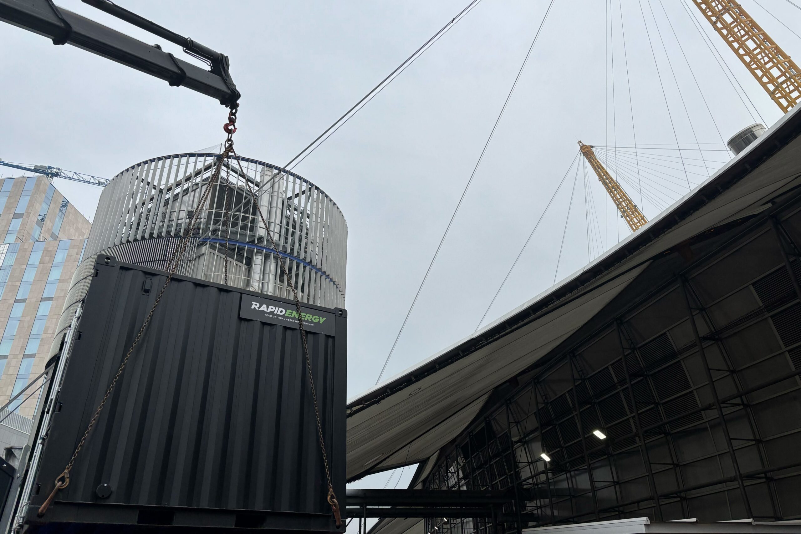 A large temporary boiler unit being lifted into position at the O2 Arena in London by Rapid Energy, a leading provider of boiler hire solutions.